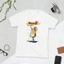 Load image into Gallery viewer, White t-shirt for men with Pina Colada sketched on it laying between homey things
